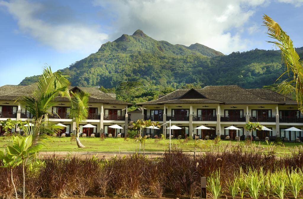Ogród i zabudowa hotelu STORY Seychelles na tle gór